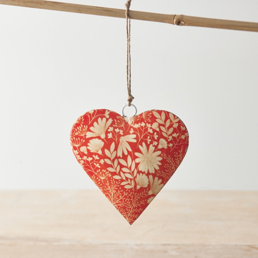 A beautiful coral coloured heart decoration with a bold floral design and jute string hanger. 