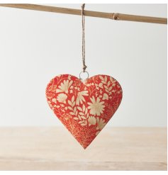 A chic heart shaped hanging decoration with a bright and bold orange and white floral design. 