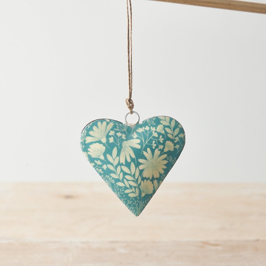 A colourful metal heart decoration with a contemporary floral print in blue and cream colours. 