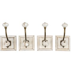 An assortment of 4 Hooks on a wooden base in a antique style.