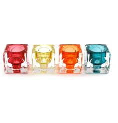 An assortment of 4 cube shaped tea light holders in bright colours.