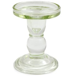 A clear small candlestick made from glass. Add this accessory to any home style decor.