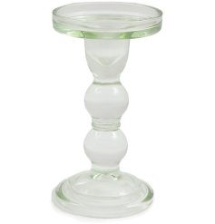 A simple elegant candlestick made from glass.