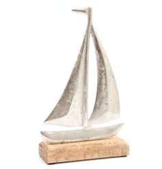 A nautical silver boat on a natural wooden base.