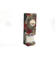 A reed diffuser in a floral Christmas Poinsettia Design, filled with a spiced cinnamon fragrance. 