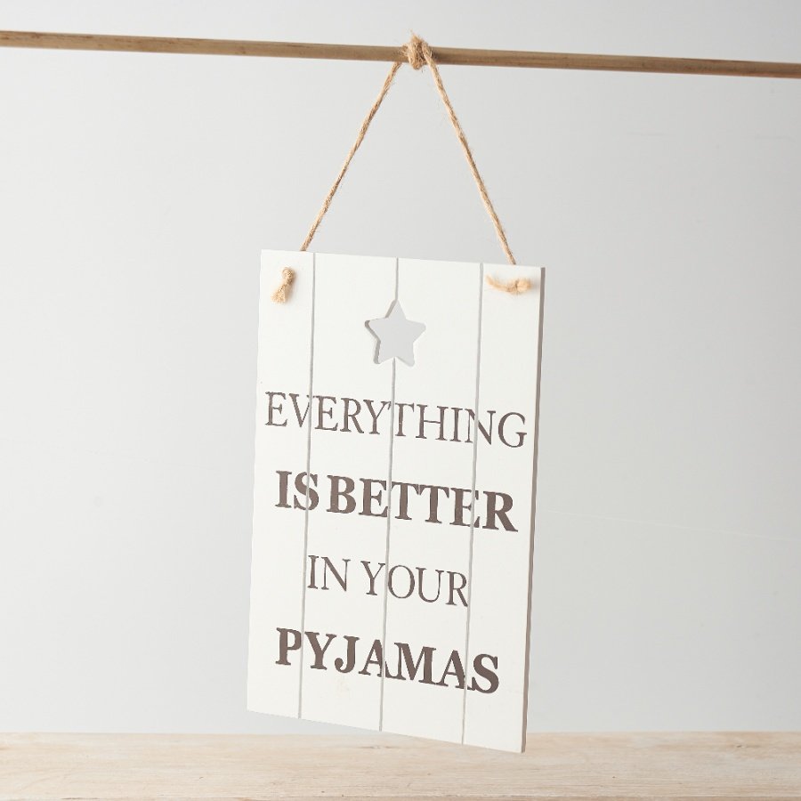 A white wooden plaque with a cut out star motif hung from jute twine.