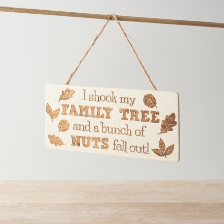 A hanging natural tone plaque displaying a comical text decal.