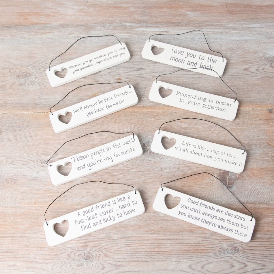 A assortment of 8 mini wooden signs each with sentimental wording an a cut out heart detail.