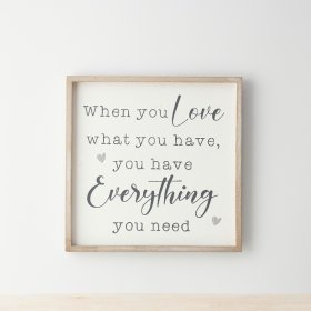 A cute wooden sign with a simple frame, displaying the words when you love what you have, you have everything you need" 