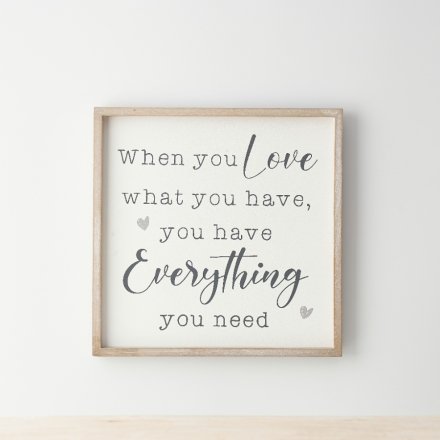 A wooden shabby chic frame sign with "when you love what you have, you have everything you need" wording.