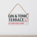 A wooden sign featuring red and black wording and a glass image.
