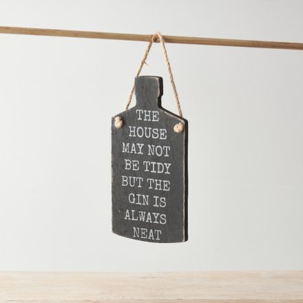 A wooden sign in a gin bottle shape with 'The house may not be tidy, but the gin is always neat' text.