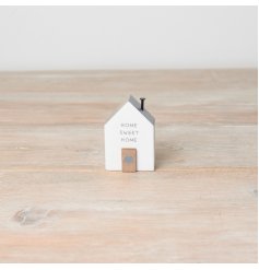 A shabby chic mini wooden house ornament. It details a screw chimney, 'home sweet home' text and a tiny wooden door