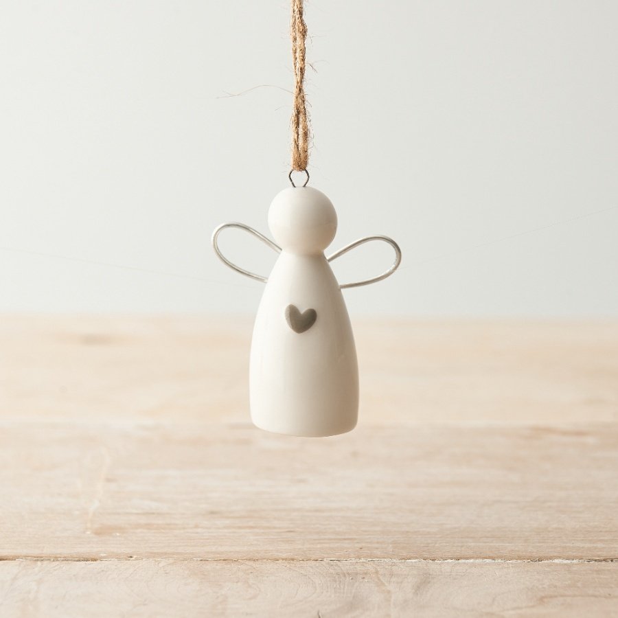 A beautiful porcelain angel decoration with silver wings and a dainty grey heart. 