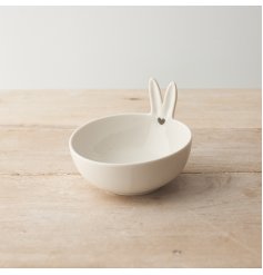 A unique white trinket dish with bunny ears that is the perfect addition to any room.