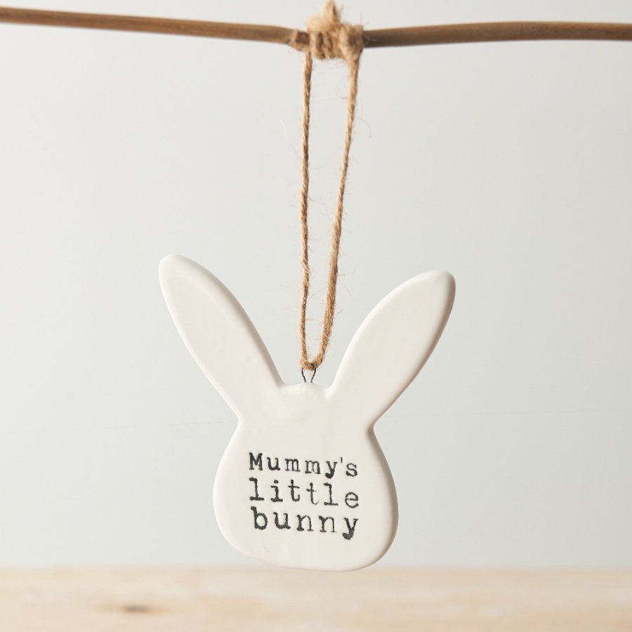 A chic porcelain decoration in the shape of a bunny. Complete with rustic jute string hanger and a stamped slogan.