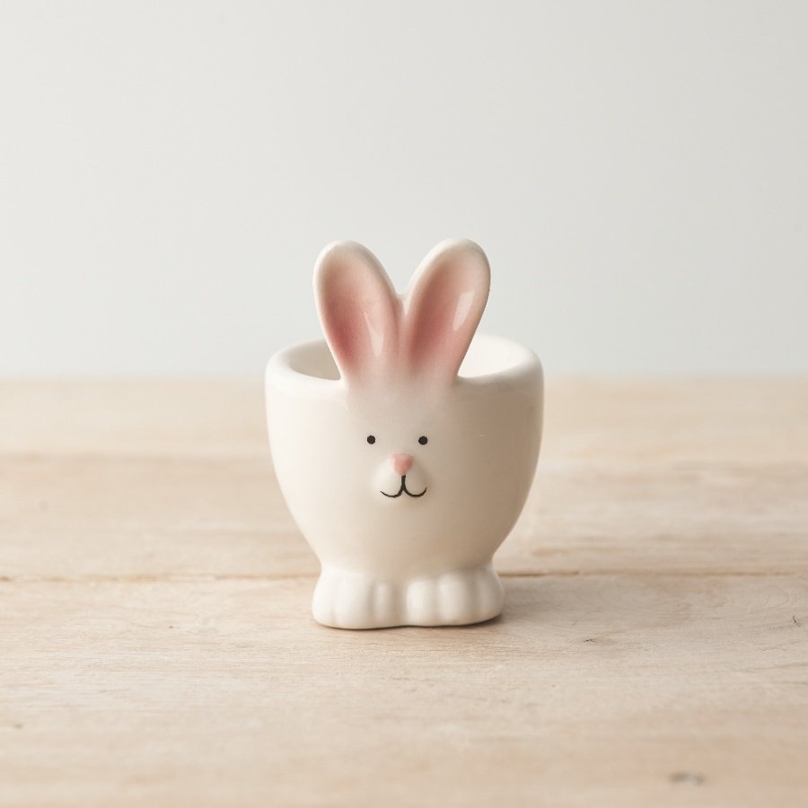 A cute bunny shaped egg cup with pastel pink details. The perfect way to enjoy chocolate or dippy eggs this season. 