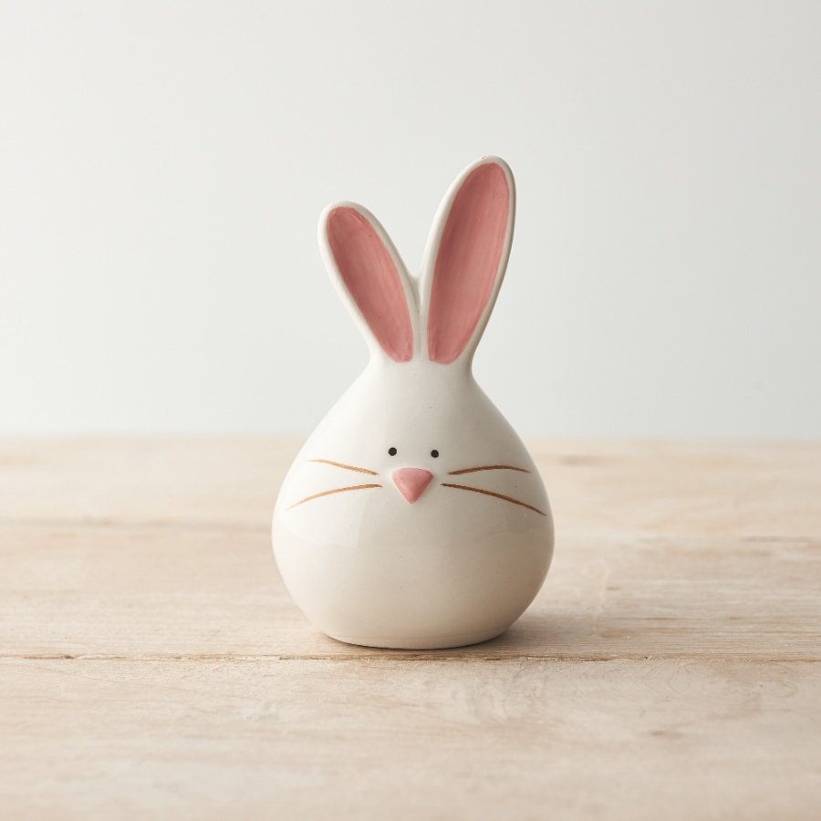 A cute bunny shaped ornament with a glossy finish and pink painterly details. 