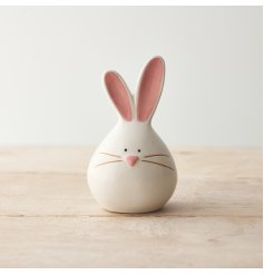 A charming bunny ornament with pastel pink details and a cute face. A lovely seasonal gift item and decoration. 