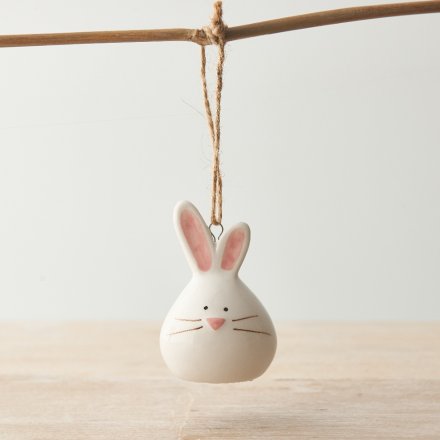 A charming bunny shaped decoration with pink pastel details and a rustic jute string hanger. 