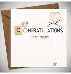A charming engagement card featuring a scrabble piece made into the word Congratulations and a little bow 