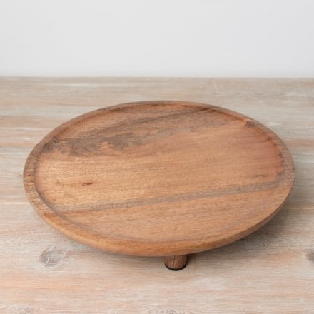 A stylish round display board with feet. Made from natural wood with a deep earthy tone. 