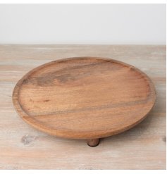 A stylish round display board with feet. Made from natural wood with a deep earthy tone. 
