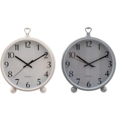 An assortment of 2 retro wall clocks in taupe and white, a charming feature to hang anywhere in the home. 