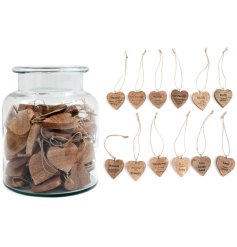 A charming glass jar filled with wooden hearts in various designs. Perfect for adding elegance and charm to any room!