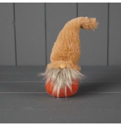 Cute fabric gonk in orange hues perfect for adding character to autumn displays