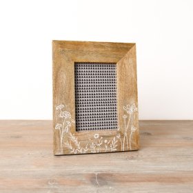A stylish photo frame with wooden frame featuring a floral meadow design. 