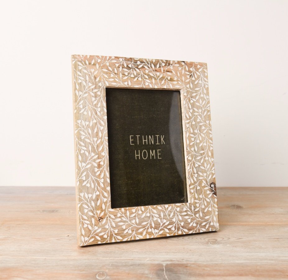 A neutral photo frame with a pretty leaf print design etched onto the front.