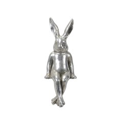 A vintage style silver rabbit ornament sat with crossed legs.