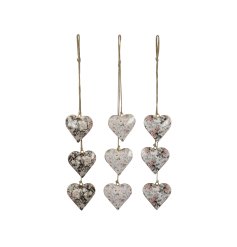 3 assorted floral hanging hearts in a cluster of 3 with a jute string hanger.