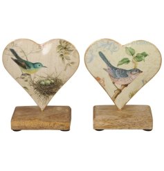 2 charming assortments of a heart shaped metal ornament with a rustic wooden stand. 