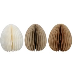 3 assorted paper egg decorations in cream and brown tones. 