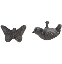 An assortment of 2 cast iron drawer knobs in a bird and butterfly sculpted design.