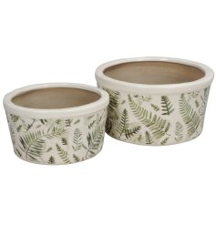 A set of 2 planters with a vibrant fern pattern detail.