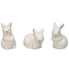 An assortment of 3 festive rabbits ornaments with a glazed finish.