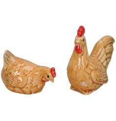 An assortment of 2 glazed chicken ornaments with intricate realistic details.