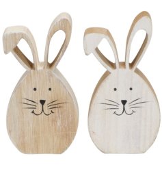 2 assorted wooden bunny ornaments in a natural tone with a painted face and big ears.