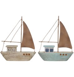 A wooden sailing boat ornament with detailed features including tiny cut out windows and a wooden sail and mast.