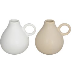 2 assorted vases in cream and white with a wide base  circular handle.