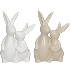 An assortment of 2 rabbit ornaments featuring a parent and child gazing at each other. 