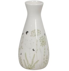 A small little vase in white with a glazed finish and detailed mini flower decals.