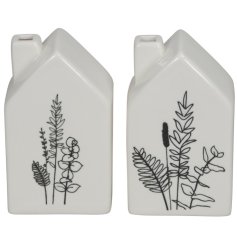 A mini house ornament in 2 assorted designs. Detailing a white glazed house with intricate black flower decals.