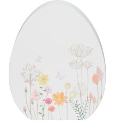 A white and multi coloured wooden egg. Perfect for the easter season. 