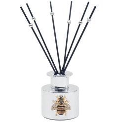 A luxury silver reed diffuser finished with a embellished jewel bee.