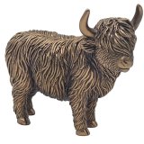 A rustic standing highland cow ornament in a bronze colour. It features rugged fur details and two bold horns