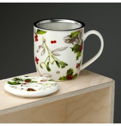 With a tea infusing sieve a beautiful winter botanicals mug with lid.